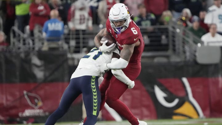 Arizona Cardinals running back James Conner (6) is tackled by Seattle Seahawks cornerback Devon Witherspoon (21) during the fourth quarter at State Farm Stadium in Glendale on Jan. 7, 2024.