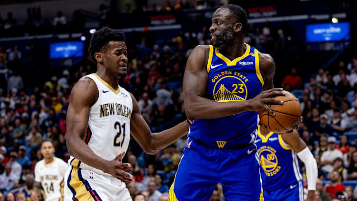 Mar 28, 2025; New Orleans, Louisiana, USA;  Golden State Warriors forward Draymond Green (23) looks to pass the ball against New Orleans Pelicans center Yves Missi (21) during the first half at Smoothie King Center. Mandatory Credit: Stephen Lew-Imagn Images