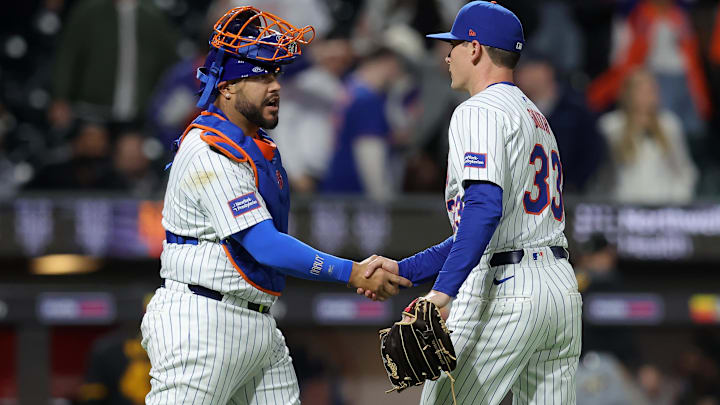 Apr 16, 2024; New York City, New York, USA; New York Mets relief pitcher Drew Smith (33) shakes hands with catcher Omar Narvaez (2) after defeating the Pittsburgh Pirates at Citi Field. Mandatory Credit: Brad Penner-Imagn Images