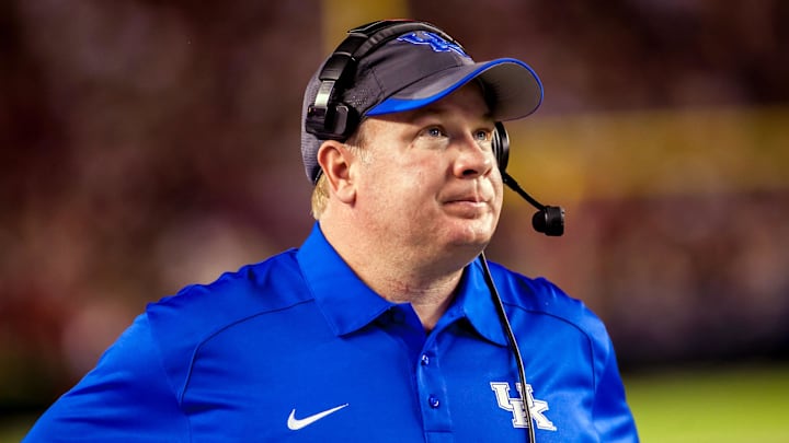 Oct 5, 2013; Columbia, SC, USA; Kentucky Wildcats head coach Mark Stoops checks the time on the scoreboard against the South Carolina Gamecocks in the second quarter at Williams-Brice Stadium. Mandatory Credit: Jeff Blake-Imagn Images