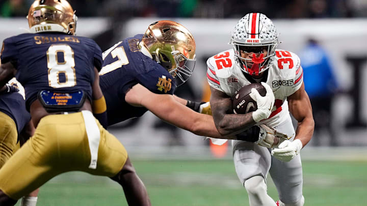 Ohio State Buckeyes running back TreVeyon Henderson (32) carries the ball on a run against Notre Dame Fighting Irish defensive lineman Gabriel Rubio (97) in the third quarter during the College Football Playoff championship at Mercedes-Benz Stadium in Atlanta on January 20, 2025.