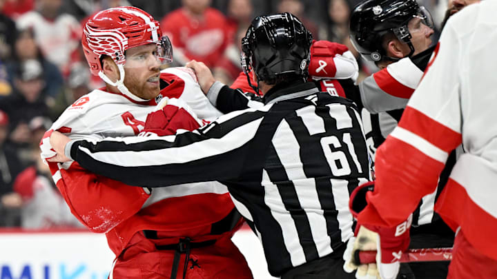 Mar 12, 2025; Detroit, Michigan, USA; The referees try and break up a fight between Detroit Red Wings left wing J.T. Compher (37) and Buffalo Sabres left wing Jordan Greenway (12) in the third period at Little Caesars Arena. Mandatory Credit: Lon Horwedel-Imagn Images
