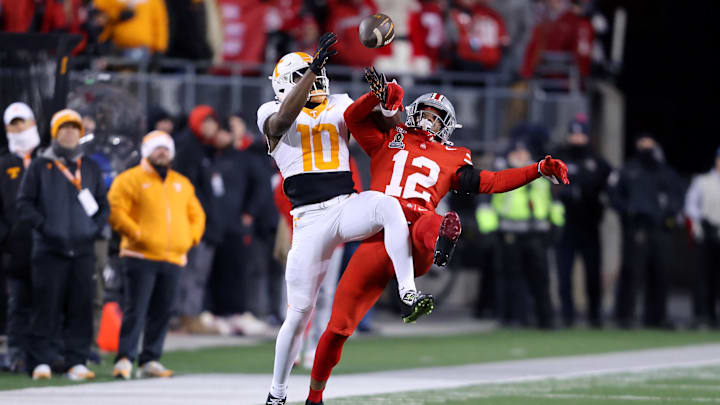 Dec 21, 2024; Columbus, Ohio, USA; Ohio State Buckeyes cornerback Bryce West (12) breaks up the deep pass intended for Tennessee Volunteers wide receiver Mike Matthews (10) passer during the third quarter at Ohio Stadium. Mandatory Credit: Joseph Maiorana-Imagn Images