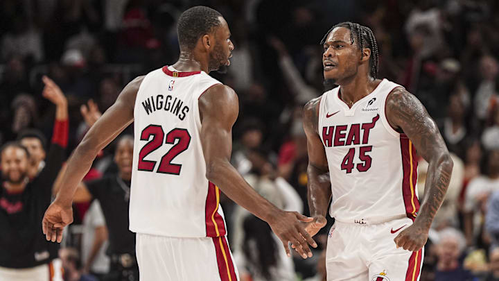 Apr 18, 2025; Atlanta, Georgia, USA; Miami Heat guard Davion Mitchell (45) reacts with forward Andrew Wiggins (22) after the Heat defeated the Atlanta Hawks in overtime at State Farm Arena. Mandatory Credit: Dale Zanine-Imagn Images