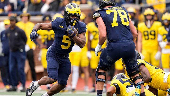 Team Blue running back Savion Hiter (5) runs against Team Maize during the spring game at Michigan Stadium in Ann Arbor on Saturday, April 18, 2026.