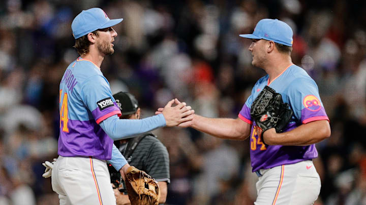 Jul 18, 2025; Denver, Colorado, USA; Colorado Rockies relief third baseman Ryan McMahon (24) celebrates with pitcher Seth Halvorsen (54) after the game against the Minnesota Twins at Coors Field. 