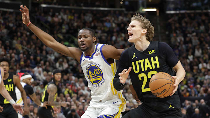 Feb 12, 2024; Salt Lake City, Utah, USA;  Utah Jazz forward Lauri Markkanen (23) is fouled by Golden State Warriors forward Jonathan Kuminga (00) during the second quarter at Delta Center. Mandatory Credit: Chris Nicoll-Imagn Images