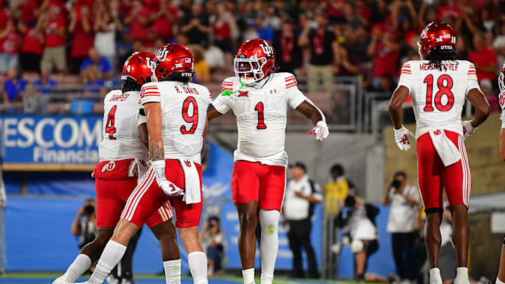 Utah Utes running back Wayshawn Parker (1) celebrates his touchdown scored against the UCLA Bruins with wide receiver Ryan Davis (9) and quarterback Devon Dampier (4) during the first half at Rose Bowl. Utah Utes running back Wayshawn Parker (1) celebrates his touchdown scored against the UCLA Bruins with wide receiver Ryan Davis (9) and quarterback Devon Dampier (4) during the first half at Rose Bowl.