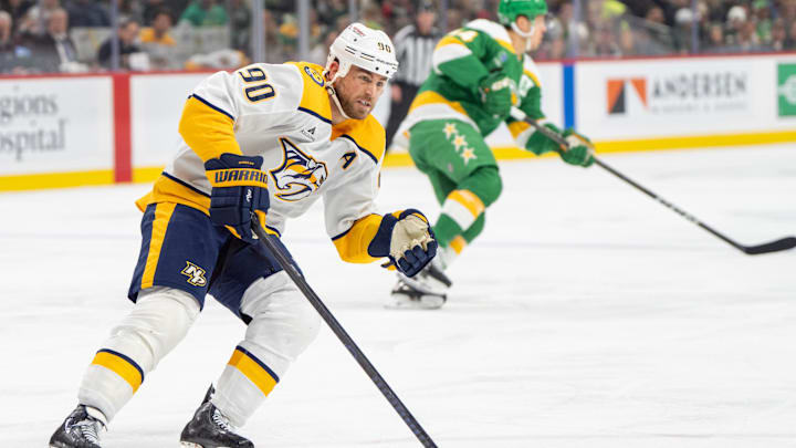 Dec 31, 2024; Saint Paul, Minnesota, USA; Nashville Predators center Ryan O'Reilly (90) pursues a Minnesota Wild player in the first period at Xcel Energy Center. Mandatory Credit: Matt Blewett-Imagn Images