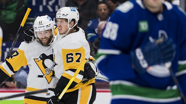 Oct 28, 2022; Vancouver, British Columbia, CAN; Pittsburgh Penguins forward Bryan Rust (17) and forward Rickard Rakell (67) celebrate Rakell   s goal against the Vancouver Canucks in the second period at Rogers Arena.  Mandatory Credit: Bob Frid-Imagn Images