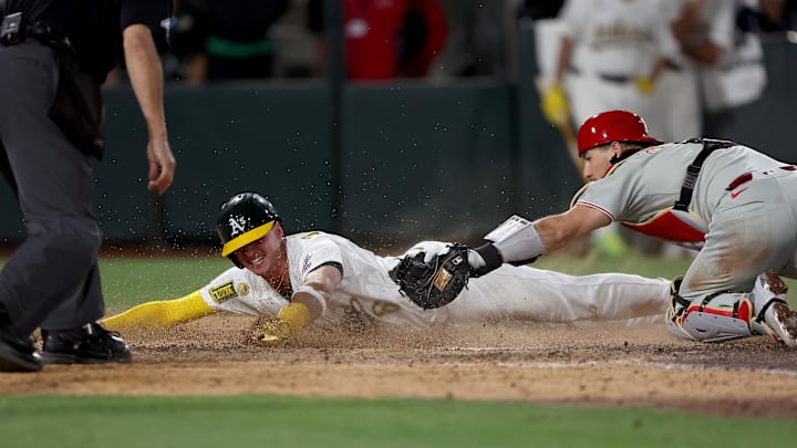 May 24, 2025; West Sacramento, California, USA; Athletics pitch runner Logan Davidson (6) is tagged out by Philadelphia Phillies catcher J.T. Realmuto (10) during the tenth inning at Sutter Health Park. Mandatory Credit: Dennis Lee-Imagn Images