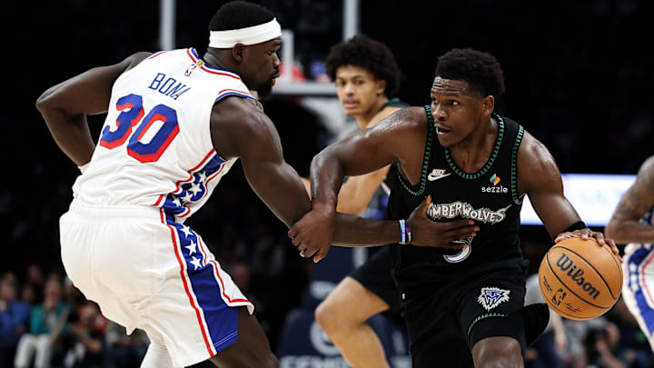Feb 22, 2026; Minneapolis, Minnesota, USA; Minnesota Timberwolves guard Anthony Edwards (5) works around Philadelphia 76ers center Adem Bona (30) during the second half at Target Center. 