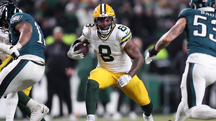 Jan 12, 2025; Philadelphia, Pennsylvania, USA; Green Bay Packers running back Josh Jacobs (8) rushes the ball against the Philadelphia Eagles during the first half in an NFC wild card game at Lincoln Financial Field. Mandatory Credit: Bill Streicher-Imagn Images