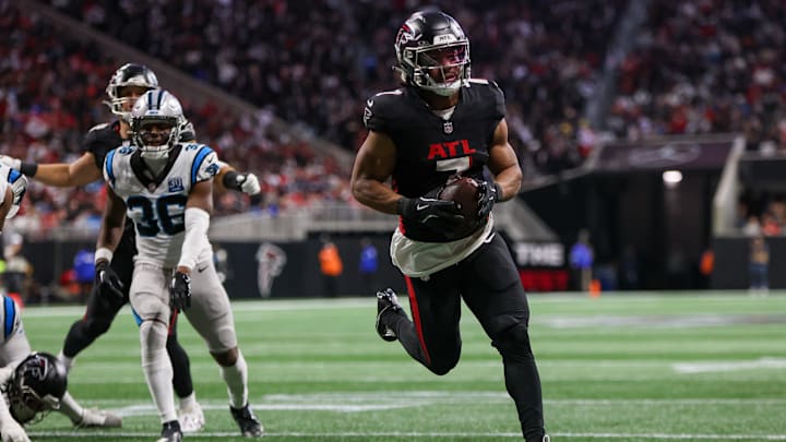Jan 5, 2025; Atlanta, Georgia, USA; Atlanta Falcons running back Bijan Robinson (7) runs the ball for a touchdown against the Carolina Panthers in the second quarter at Mercedes-Benz Stadium. Mandatory Credit: Brett Davis-Imagn Images