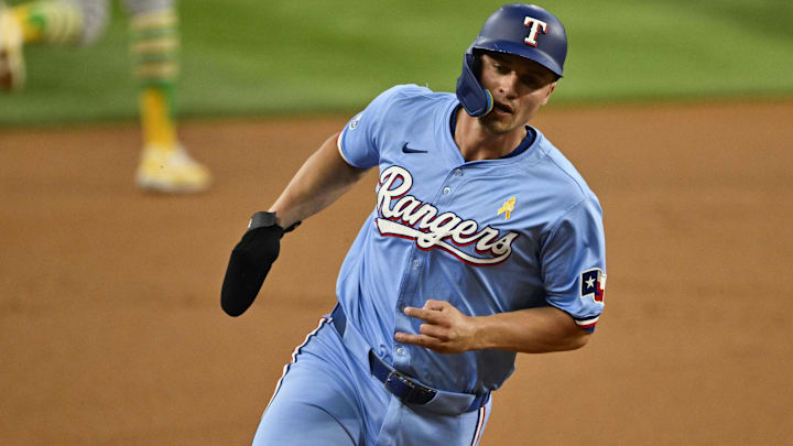 Sep 1, 2024; Arlington, Texas, USA; Texas Rangers shortstop Corey Seager (5) scores from second base on a double hit by right fielder Adolis Garcia (not pictured) during the first inning at Globe Life Field. 