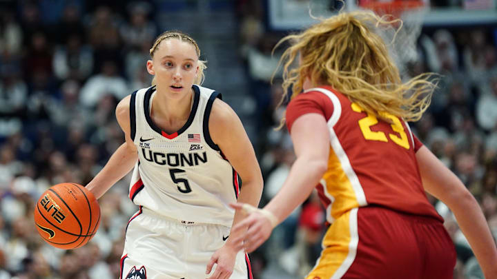 Dec 21, 2024; Hartford, Connecticut, USA; UConn Huskies guard Paige Bueckers (5) moves the ball against USC Trojans guard Avery Howell (23) in the first half at XL Center. Mandatory Credit: David Butler II-Imagn Images Dec 21, 2024; Hartford, Connecticut, USA; UConn Huskies guard Paige Bueckers (5) moves the ball against USC Trojans guard Avery Howell (23) in the first half at XL Center. Mandatory Credit: David Butler II-Imagn Images