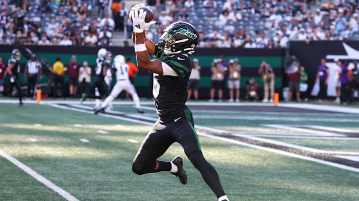 Oct 5, 2025; East Rutherford, New Jersey, USA; New York Jets wide receiver Garrett Wilson (5) makes a catch during the second half of a game against the Dallas Cowboys at MetLife Stadium. Mandatory Credit: Vincent Carchietta-Imagn Images