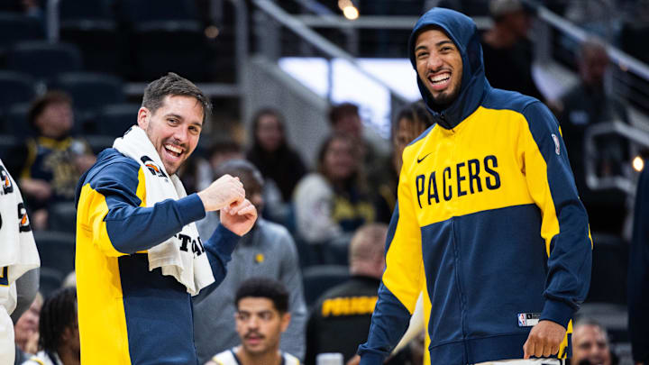 Oct 17, 2024; Indianapolis, Indiana, USA; Indiana Pacers guard T.J. McConnell (9) and  guard Tyrese Haliburton (0) cheer in the second half against the Charlotte Hornets at Gainbridge Fieldhouse. Mandatory Credit: Trevor Ruszkowski-Imagn Images