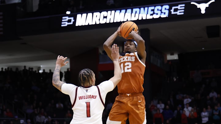 Mar 17, 2026; Dayton, OH, USA; Texas Longhorns guard Tramon Mark (12) shoots the ball over NC State Wolfpack forward Darrion Williams (1) in the second half during a first four game of the men's 2026 NCAA Tournament at University of Dayton Arena. Mandatory Credit: Rick Osentoski-Imagn Images