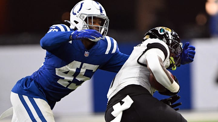 Jan 5, 2025; Indianapolis, Indiana, USA; Indianapolis Colts linebacker E.J. Speed (45) tackles Jacksonville Jaguars running back Travis Etienne Jr. (1) during the second half at Lucas Oil Stadium. Mandatory Credit: Marc Lebryk-Imagn Images