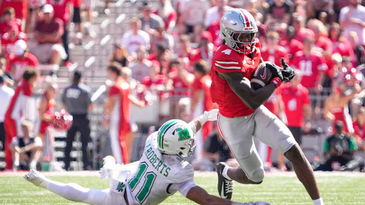 Sep 21, 2024; Columbus, Ohio, USA; Ohio State Buckeyes wide receiver Jeremiah Smith (4) runs the ball against Marshall Thundering Herd defensive back J.J. Roberts (11) in the second half at Ohio Stadium on Saturday.