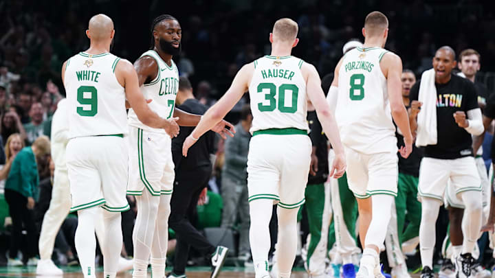 Jun 6, 2024; Boston, Massachusetts, USA; Boston Celtics forward Sam Hauser (30) and guard Jaylen Brown (7) react in the first quarter against the Dallas Mavericks during game one of the 2024 NBA Finals at TD Garden. Mandatory Credit: David Butler II-Imagn Images