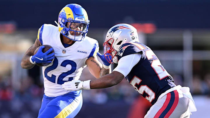 Nov 17, 2024; Foxborough, Massachusetts, USA; Los Angeles Rams running back Blake Corum (22) runs with the ball against New England Patriots cornerback Marcus Jones (25) during the first half at Gillette Stadium. Mandatory Credit: Brian Fluharty-Imagn Images