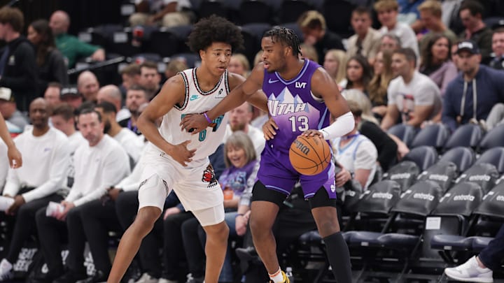 Mar 25, 2025; Salt Lake City, Utah, USA;  Utah Jazz guard Isaiah Collier (13) keeps Memphis Grizzlies forward Jaylen Wells (0) away from the ball during the second half at Delta Center. Mandatory Credit: Chris Nicoll-Imagn Images