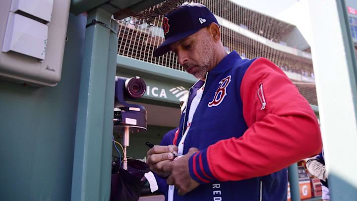 Apr 20, 2026; Boston, Massachusetts, USA; Boston Red Sox manager Alex Cora signs a baseball for a fan prior to a game against the Detroit Tigers at Fenway Park. Mandatory Credit: Bob DeChiara-Imagn Images