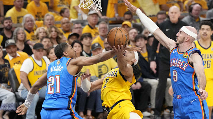 Jun 11, 2025; Indianapolis, Indiana, USA; Oklahoma City Thunder guard Aaron Wiggins (21) and guard Alex Caruso (9) block the shot of Indiana Pacers guard Andrew Nembhard (2) during the first half of game three of the 2025 NBA Finals at Gainbridge Fieldhouse. Mandatory Credit: Kyle Terada-Imagn Images