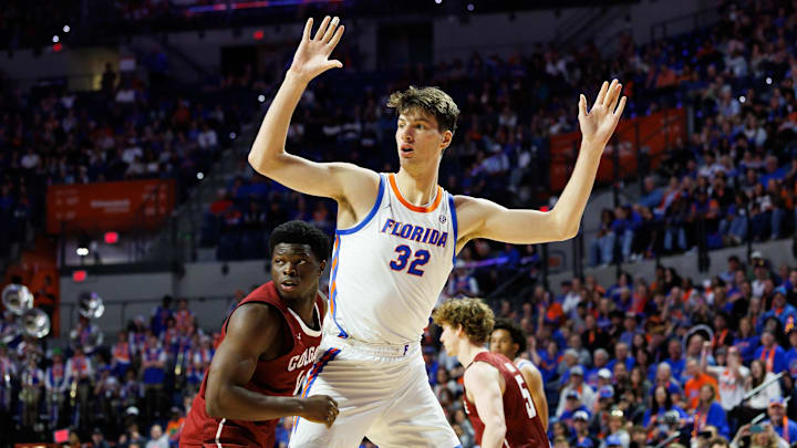 Dec 21, 2025; Gainesville, Florida, USA; Florida Gators center Olivier Rioux (32) calls for the ball while Colgate Raiders guard Josh Ahayere (4) defends during the second half at Exactech Arena at the Stephen C. O'Connell Center. Mandatory Credit: Matt Pendleton-Imagn Images