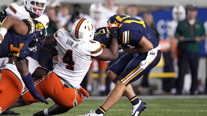 Oct 5, 2024; Berkeley, California, USA; Miami Hurricanes defensive lineman Rueben Bain Jr. (4) sacks California Golden Bears quarterback Fernando Mendoza (right) during the fourth quarter at California Memorial Stadium. Mandatory Credit: Darren Yamashita-Imagn Images