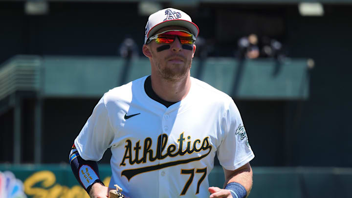 Jul 4, 2024; Oakland, California, USA; Oakland Athletics third baseman Brett Harris (77) jogs to the dugout before the game against the Los Angeles Angels at Oakland-Alameda County Coliseum. Mandatory Credit: Kelley L Cox-Imagn Images