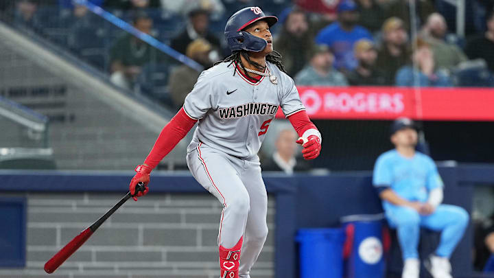 Apr 2, 2025; Toronto, Ontario, CAN; Washington Nationals shortstop CJ Abrams (5) hits a fly ball against the Toronto Blue Jays during the first inning at Rogers Centre.