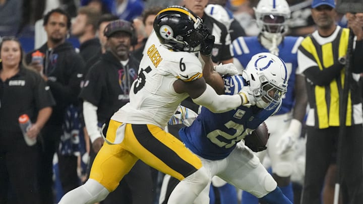 Sep 29, 2024; Indianapolis, Indiana, USA; Indianapolis Colts running back Jonathan Taylor (28) pushes off Pittsburgh Steelers linebacker Patrick Queen (6) at Lucas Oil Stadium. Mandatory Credit: Christine Tannous-USA TODAY Network via Imagn Images
