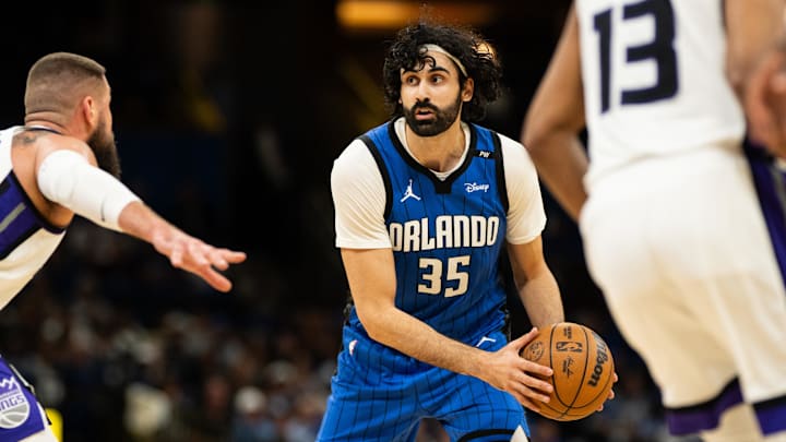 Mar 29, 2025; Orlando, Florida, USA; Orlando Magic center Goga Bitadze (35) looks for the pass against Sacramento Kings center Jonas Valančiūnas (17) in the fourth quarter at Kia Center. Mandatory Credit: Jeremy Reper-Imagn Images