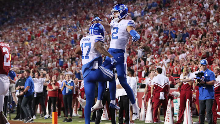 Sep 16, 2023; Fayetteville, Arkansas, USA; BYU Cougars wide receiver Chase Roberts (2) celebrates with wide receiver Keelan Marion (17) after catching a pass for a touchdown in the fourth quarter against the Arkansas Razorbacks at Donald W. Reynolds Razorback Stadium. BYU won 38-31. Mandatory Credit: Nelson Chenault-Imagn Images