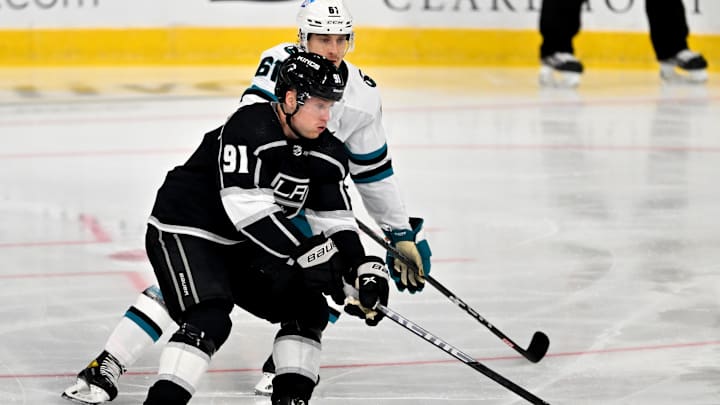 Sep 28, 2022; Ontario, California, USA;  Los Angeles Kings right wing Carl Grundstrom (91) and San Jose Sharks defenseman Santeri Hatakka (61) battle for the puck during a preseason at Toyota Arena. Mandatory Credit: Jayne Kamin-Oncea-USA TODAY Sports