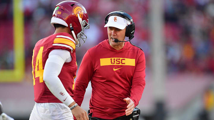 Nov 16, 2024; Los Angeles, California, USA; Southern California Trojans head coach Lincoln Riley greets quarterback Jayden Maiava (14) after scoring a touchdown against the Nebraska Cornhuskers during the second half at the Los Angeles Memorial Coliseum. Mandatory Credit: Gary A. Vasquez-Imagn Images