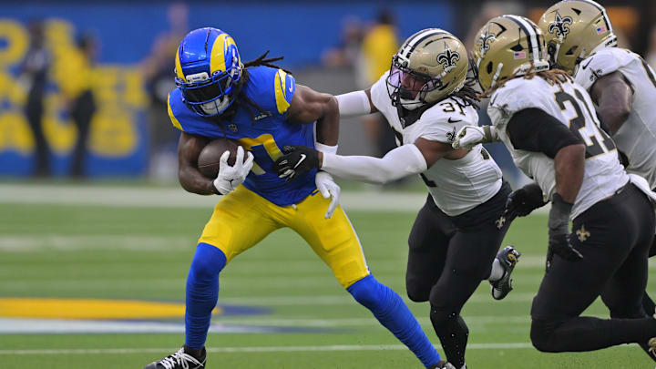 Nov 2, 2025; Inglewood, California, USA; Los Angeles Rams wide receiver Davante Adams (17) runs after the catch as New Orleans Saints safety Jordan Howden (31) defends during the second half at SoFi Stadium. Mandatory Credit: Jayne Kamin-Oncea-Imagn Images