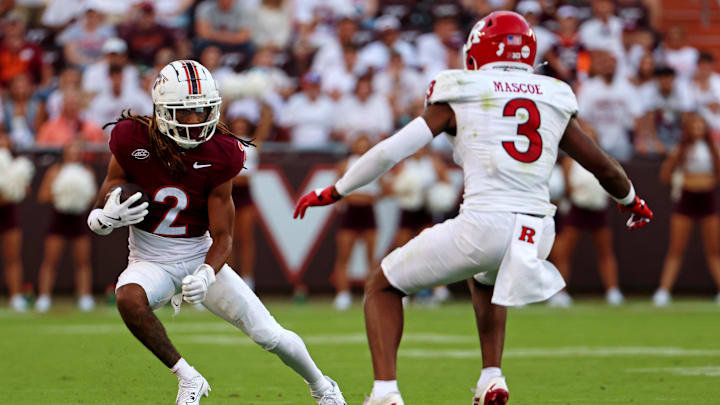Sep 21, 2024; Blacksburg, Virginia, USA; Virginia Tech Hokies wide receiver Takye Heath (2) runs the ball against Rutgers Scarlet Knights defensive back Bo Mascoe (3) during the fourth quarter at Lane Stadium. Mandatory Credit: Peter Casey-Imagn Images