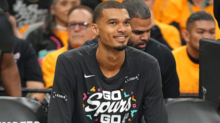 Apr 19, 2026; San Antonio, Texas, USA; San Antonio Spurs forward Victor Wembanyama (1) sits on the bench before game one of the first round of the 2026 NBA Playoffs against the Portland Trail Blazers at Frost Bank Center.