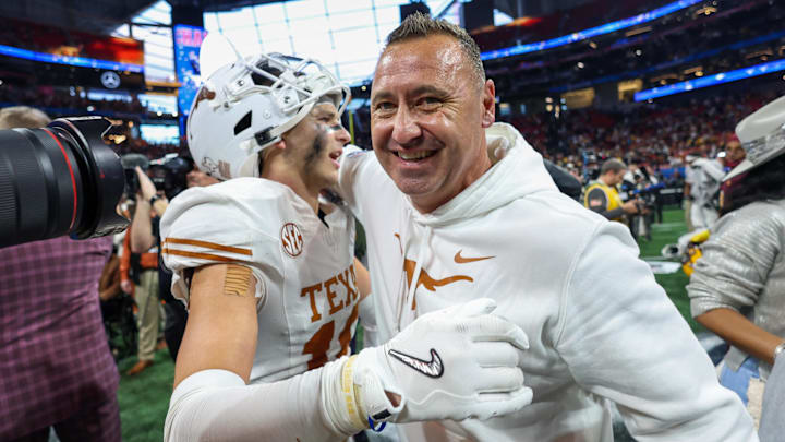 Jan 1, 2025; Atlanta, GA, USA; Texas Longhorns defensive back Michael Taaffe (16) and head coach Steve Sarkisian celebrate after a victory over the Arizona State Sun Devils in the Peach Bowl at Mercedes-Benz Stadium. Mandatory Credit: Brett Davis-Imagn Images