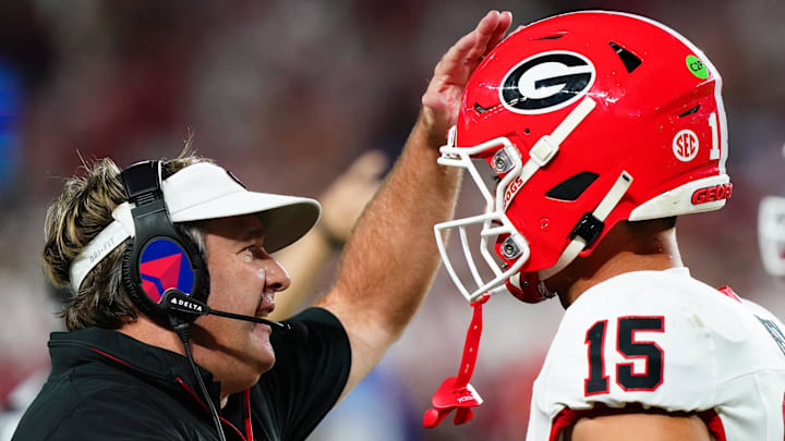Sep 28, 2024; Tuscaloosa, Alabama, USA;  Georgia Bulldogs head coach Kirby Smart talks with quarterback Carson Beck (15) during the first half against the Alabama Crimson Tide at Bryant-Denny Stadium. Mandatory Credit: John David Mercer-Imagn Images