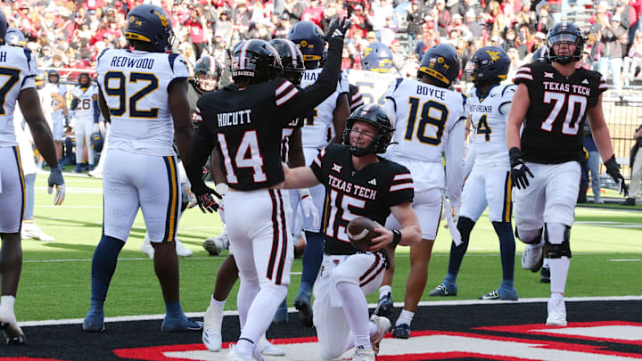 Nov 30, 2024; Lubbock, Texas, USA; Texas Tech Red Raiders quarterback Will Hammond (15) celebrates with wide receiver Drew Hocutt (14) after scoring a touchdown against the West Virginia Mountaineers in the second half at Jones AT&T Stadium and Cody Campbell Field. Mandatory Credit: Michael C. Johnson-Imagn Images Nov 30, 2024; Lubbock, Texas, USA; Texas Tech Red Raiders quarterback Will Hammond (15) celebrates with wide receiver Drew Hocutt (14) after scoring a touchdown against the West Virginia Mountaineers in the second half at Jones AT&T Stadium and Cody Campbell Field. Mandatory Credit: Michael C. Johnson-Imagn Images