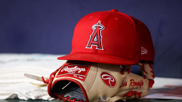 Aug 1, 2023; Atlanta, Georgia, USA; A detailed view of a Los Angeles Angels hat and glove on the bench against the Atlanta Braves in the eighth inning at Truist Park. Mandatory Credit: Brett Davis-Imagn Images