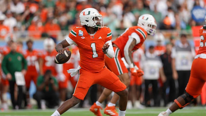 Dec 28, 2024; Orlando, FL, USA; Miami Hurricanes quarterback Cam Ward (1) drops back to pass against the Iowa State Cyclones in the first quarter during the Pop Tarts bowl at Camping World Stadium. Mandatory Credit: Nathan Ray Seebeck-Imagn Images Dec 28, 2024; Orlando, FL, USA; Miami Hurricanes quarterback Cam Ward (1) drops back to pass against the Iowa State Cyclones in the first quarter during the Pop Tarts bowl at Camping World Stadium. Mandatory Credit: Nathan Ray Seebeck-Imagn Images