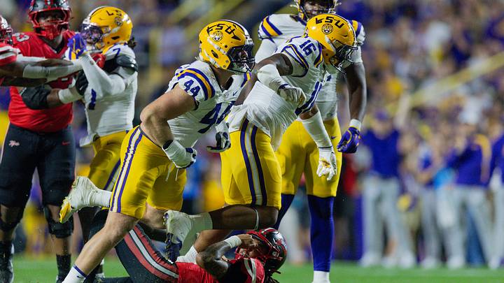 Nov 22, 2025; Baton Rouge, Louisiana, USA;  Western Kentucky Hilltoppers quarterback Rodney Tisdale Jr. (16) is sacked by LSU Tigers defensive tackle Ahmad Breaux (16) and defensive end Jack Pyburn (44) during the first half at Tiger Stadium. Mandatory Credit: Stephen Lew-Imagn Images
