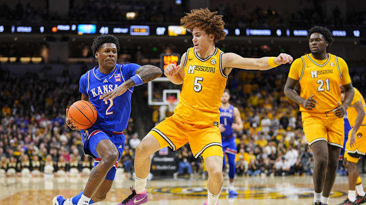 Dec 8, 2024; Columbia, Missouri, USA; Kansas Jayhawks guard AJ Storr (2) drives against Missouri Tigers guard T.O. Barrett (5) during the second half at Mizzou Arena. Mandatory Credit: Jay Biggerstaff-Imagn Images