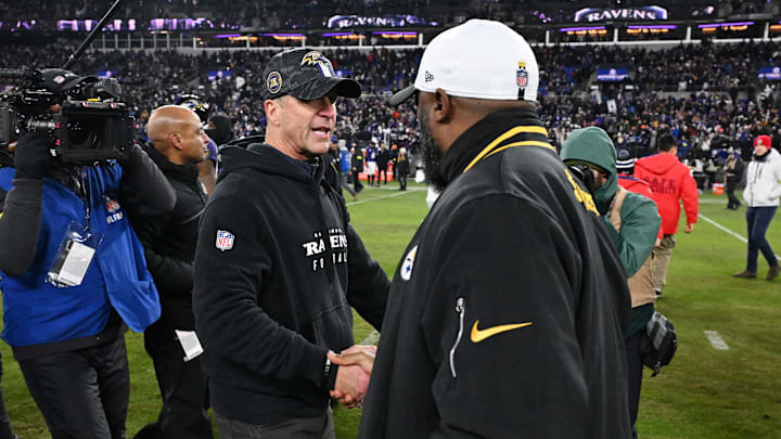 Baltimore Ravens head coach John Harbaugh shakes hands with Pittsburgh Steelers head coach Mike Tomlin.